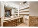 Bathroom with neutral walls, granite vanity with vessel sink, and open shelving at 804 N Shore Dr, Anna Maria, FL 34216