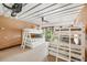 ' bedroom features two sets of white-framed bunk beds and neutral toned walls, and wood-framed window at 804 N Shore Dr, Anna Maria, FL 34216