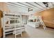 Bedroom featuring two sets of white bunk beds, wood ceiling fan, and light-colored walls and carpet at 804 N Shore Dr, Anna Maria, FL 34216