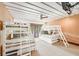 ' bedroom features two sets of white-framed bunk beds and neutral toned walls, and wood-framed window at 804 N Shore Dr, Anna Maria, FL 34216