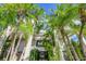 Stunning entrance, lined by tall palms and verdant landscaping, welcomes you to this tropical oasis at 804 N Shore Dr, Anna Maria, FL 34216