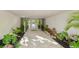 Courtyard style entrance with limestone pavers, tropical foliage, and glass doors at 804 N Shore Dr, Anna Maria, FL 34216