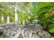 Landscaped walkway with trees leading to a gate, and brick driveway at 804 N Shore Dr, Anna Maria, FL 34216