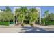 A front exterior of a multi-story property with palm trees and lush landscaping at 804 N Shore Dr, Anna Maria, FL 34216