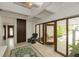 Bright foyer with tile floor, wood door, and tropical plants outside at 804 N Shore Dr, Anna Maria, FL 34216