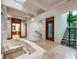 Hallway with white brick hot tub, stone floors, and lots of natural light at 804 N Shore Dr, Anna Maria, FL 34216