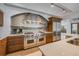 Modern kitchen with stainless steel appliances, arched range hood, tile backsplash and custom cabinets at 804 N Shore Dr, Anna Maria, FL 34216