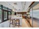 Spacious kitchen featuring stainless steel appliances, custom wooden cabinets and tile flooring at 804 N Shore Dr, Anna Maria, FL 34216