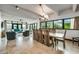 A bright living room offers a view of the exterior, an open floor plan, and access to the kitchen at 804 N Shore Dr, Anna Maria, FL 34216