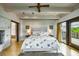 Bright main bedroom features a ceiling fan, neutral walls, and a door to the exterior at 804 N Shore Dr, Anna Maria, FL 34216
