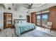 The main bedroom offers light wood floors, a walk in closet, and a door to a balcony at 804 N Shore Dr, Anna Maria, FL 34216