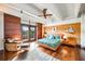 Spacious main bedroom with hardwood floors, area rug, wood wall paneling, and balcony at 804 N Shore Dr, Anna Maria, FL 34216