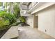 An outdoor patio with stone flooring and a bench near the exterior shower at 804 N Shore Dr, Anna Maria, FL 34216