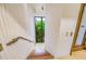 A tiled staircase with a wood banister leads to a window and an exterior view at 804 N Shore Dr, Anna Maria, FL 34216