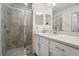 Bathroom boasts a modern shower with gray tiling and a vanity with bright white cabinets at 850 Tidewater Shores Loop # 102, Bradenton, FL 34208