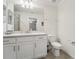 Bright bathroom featuring quartz countertops, a toilet, and a mirrored vanity at 850 Tidewater Shores Loop # 102, Bradenton, FL 34208