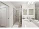 Inviting bathroom featuring a glass-enclosed shower and a mirrored vanity with white cabinets at 850 Tidewater Shores Loop # 102, Bradenton, FL 34208