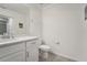 Well-lit bathroom with a toilet, large mirror, and bright white vanity at 850 Tidewater Shores Loop # 102, Bradenton, FL 34208