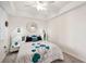 Bright bedroom with a tray ceiling, mirrored accents, and stylish bedside lamps at 850 Tidewater Shores Loop # 102, Bradenton, FL 34208