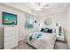 Stylish bedroom with floral-patterned bedding, side tables and a sunlit window at 850 Tidewater Shores Loop # 102, Bradenton, FL 34208