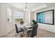 Bright dining area with a round glass table, modern chairs, and a window offering natural light and views at 850 Tidewater Shores Loop # 102, Bradenton, FL 34208