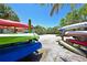 Assortment of colorful kayaks stored neatly near a scenic launch area with palm trees at 850 Tidewater Shores Loop # 102, Bradenton, FL 34208