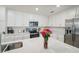 Clean kitchen with stainless steel appliances, white cabinets and quartz countertops at 850 Tidewater Shores Loop # 102, Bradenton, FL 34208