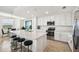 Bright kitchen with white cabinets, quartz countertops, stainless steel appliances and an island with seating at 850 Tidewater Shores Loop # 102, Bradenton, FL 34208