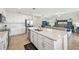 Open kitchen with stainless steel appliances, quartz countertops, white cabinets and a view of the living room at 850 Tidewater Shores Loop # 102, Bradenton, FL 34208