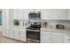 Modern kitchen featuring stainless steel appliances, quartz countertops and white cabinets at 850 Tidewater Shores Loop # 102, Bradenton, FL 34208