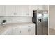 Kitchen featuring stainless steel refrigerator, quartz countertops, and white cabinets at 850 Tidewater Shores Loop # 102, Bradenton, FL 34208