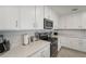 Bright kitchen featuring quartz countertops, stainless steel appliances and white cabinets at 850 Tidewater Shores Loop # 102, Bradenton, FL 34208