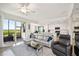 Living room featuring view of modern kitchen, comfortable seating, and sliding glass door with views at 850 Tidewater Shores Loop # 102, Bradenton, FL 34208
