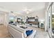Bright living room with neutral palette, tile floors, mirrored wall, and sliding glass doors to balcony at 850 Tidewater Shores Loop # 102, Bradenton, FL 34208