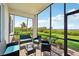 Screened patio with outdoor seating featuring a beautiful tropical view at 850 Tidewater Shores Loop # 102, Bradenton, FL 34208