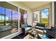 Screened patio with outdoor seating featuring view of tropical landscaping and ocean at 850 Tidewater Shores Loop # 102, Bradenton, FL 34208