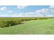 Expansive grassy area with lush bushes overlooking a beautiful body of water at 850 Tidewater Shores Loop # 102, Bradenton, FL 34208