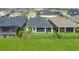 Aerial view of backyard showing the patio and landscaping; neighborhood in the distance at 8706 Arrow Creek Dr, Parrish, FL 34219