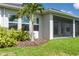 Backyard with a small palm tree, lawn, mulch, and a screened-in lanai at 8706 Arrow Creek Dr, Parrish, FL 34219