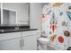 Bright bathroom featuring a single sink vanity and a shower with a fun, space-themed curtain at 8706 Arrow Creek Dr, Parrish, FL 34219