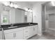 Bathroom features a double vanity with black countertop, large mirror, and walk-in closet at 8706 Arrow Creek Dr, Parrish, FL 34219