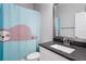 Bathroom with vanity, mirror, toilet and whimsical sloth shower curtain at 8706 Arrow Creek Dr, Parrish, FL 34219