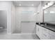 Modern bathroom with a glass-enclosed shower and sleek vanity with black countertop at 8706 Arrow Creek Dr, Parrish, FL 34219