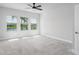 Bright bedroom with three windows offering peaceful views of the backyard pond at 8706 Arrow Creek Dr, Parrish, FL 34219