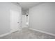 Neutral bedroom with gray carpet, white trim, and two white doors at 8706 Arrow Creek Dr, Parrish, FL 34219