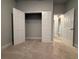 Empty bedroom with an open closet and doorways, fresh carpet and neutral color scheme creates a blank canvas at 8706 Arrow Creek Dr, Parrish, FL 34219