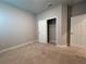 Clean bedroom showcasing carpet, walk-in closet, and white doors at 8706 Arrow Creek Dr, Parrish, FL 34219