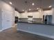 Modern kitchen features a large island with sink, stainless appliances, and ample counter space at 8706 Arrow Creek Dr, Parrish, FL 34219