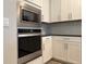 Close-up view of the stainless steel microwave and oven, complemented by the sleek countertops at 8706 Arrow Creek Dr, Parrish, FL 34219