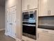 Modern stainless steel oven and microwave combination, located near pantry at 8706 Arrow Creek Dr, Parrish, FL 34219